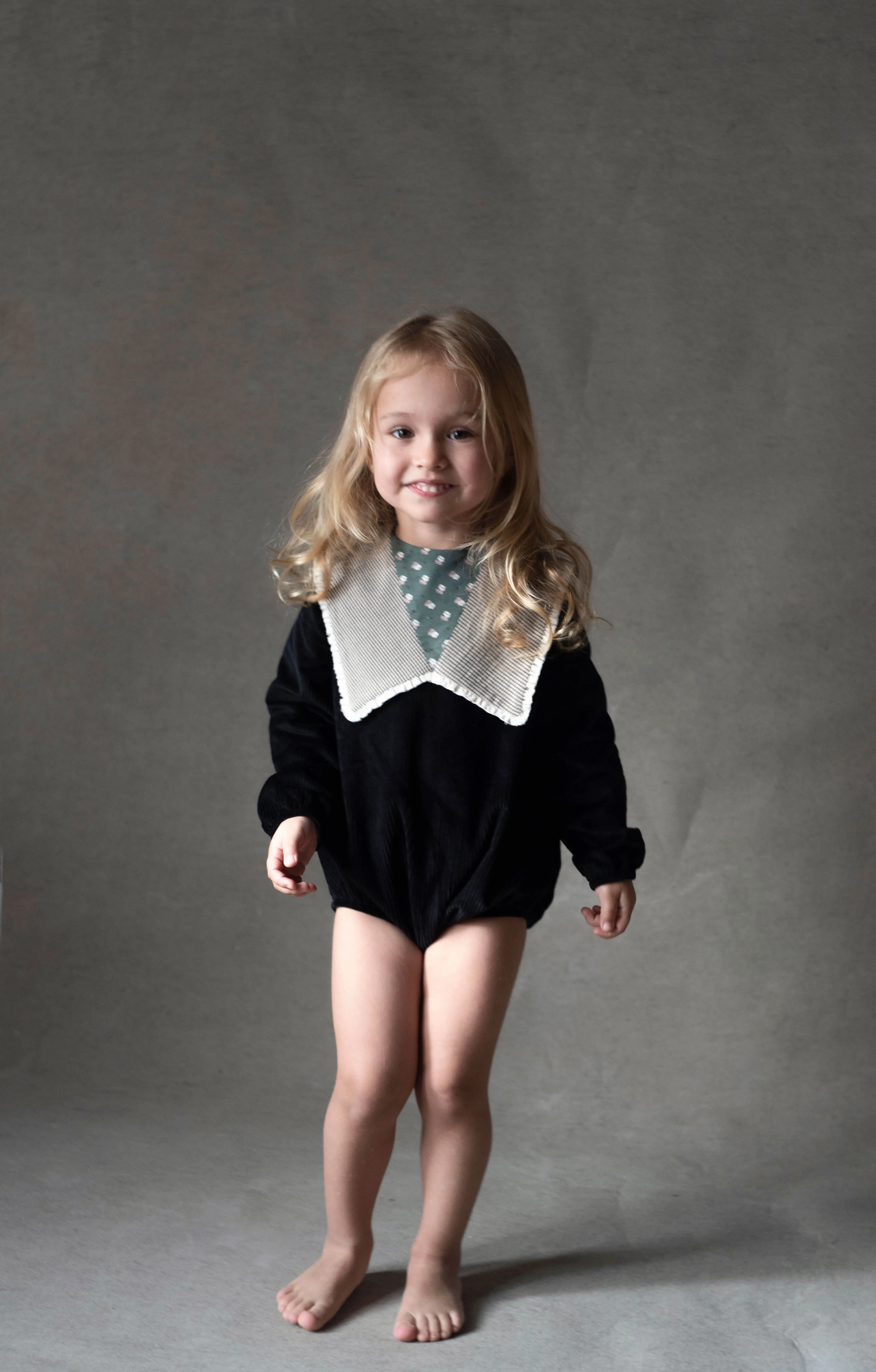 1.4-BLACK ROMPER SUIT W/ OVERSIZED BIBI COLLAR